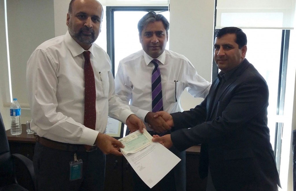 HBL Foundation officers (left) present check to Javed Iqbal (right), Executive Director, Friends Welfare Association.